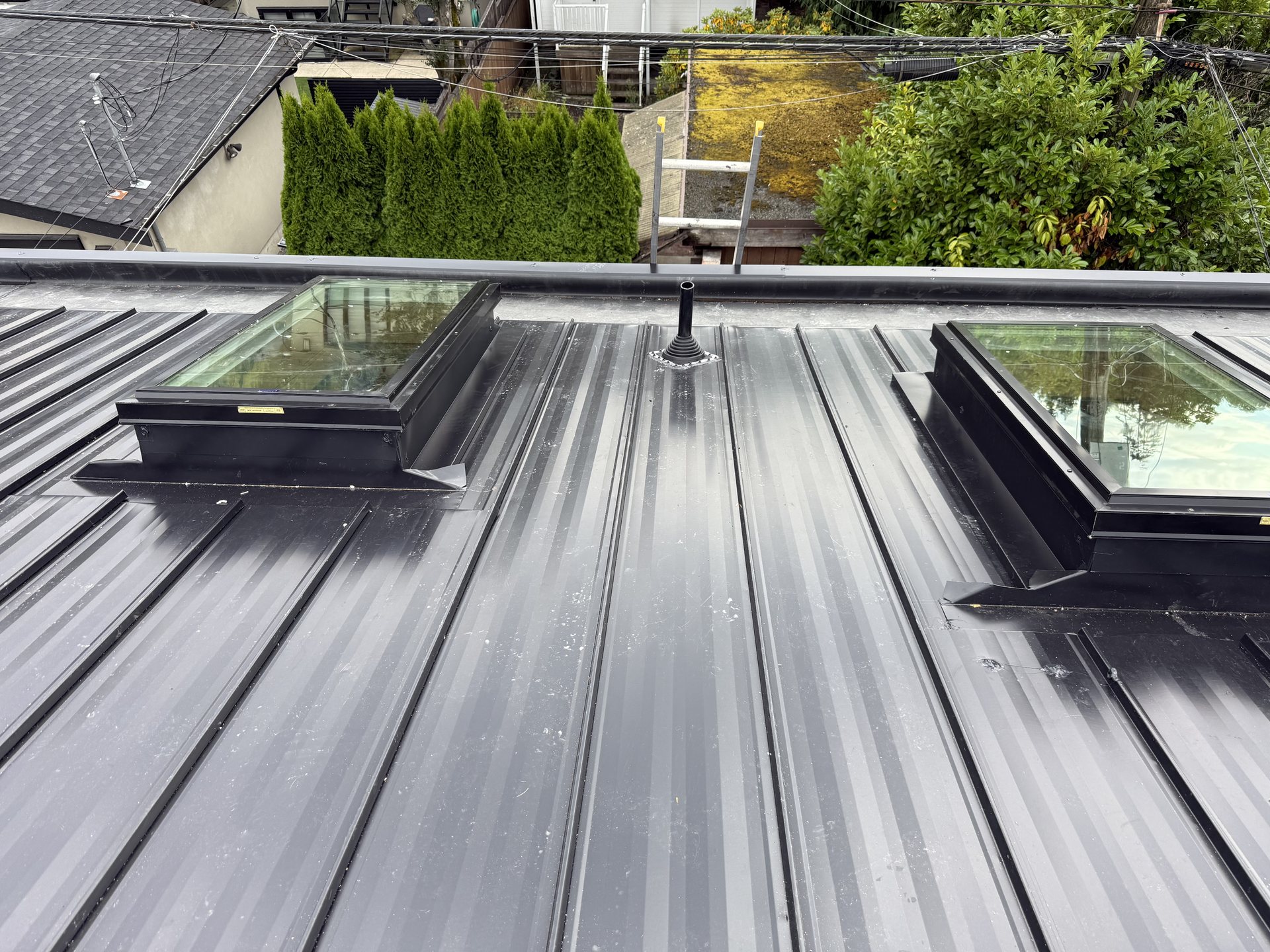 Standing-seam metal detail with concealed clips and hemmed valley